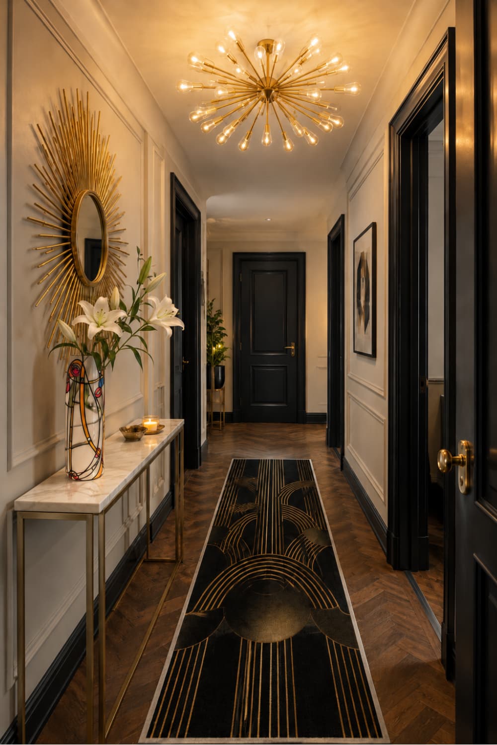 Dramatic Neo Deco hallway with gold Sputnik chandelier, sunburst mirror, black and gold Art Deco runner and marble console table
